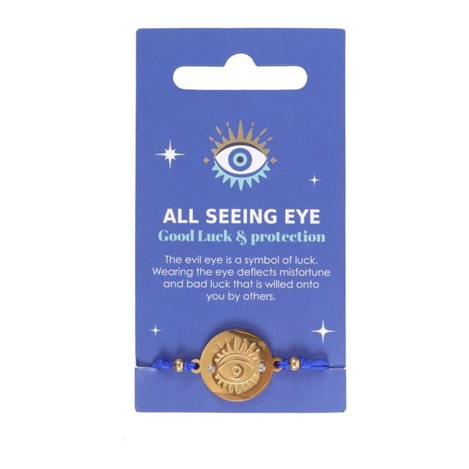 Gold-toned all seeing eye string bracelet with blue string on a blue card