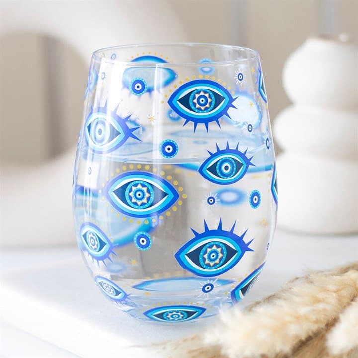Stemless glass with a blue all seeing eye print and gold-tone stars