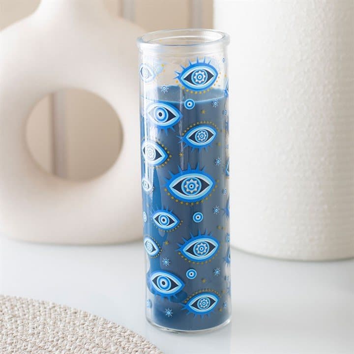 Dark blue tube candle with an all seeing eye print on the glass tube