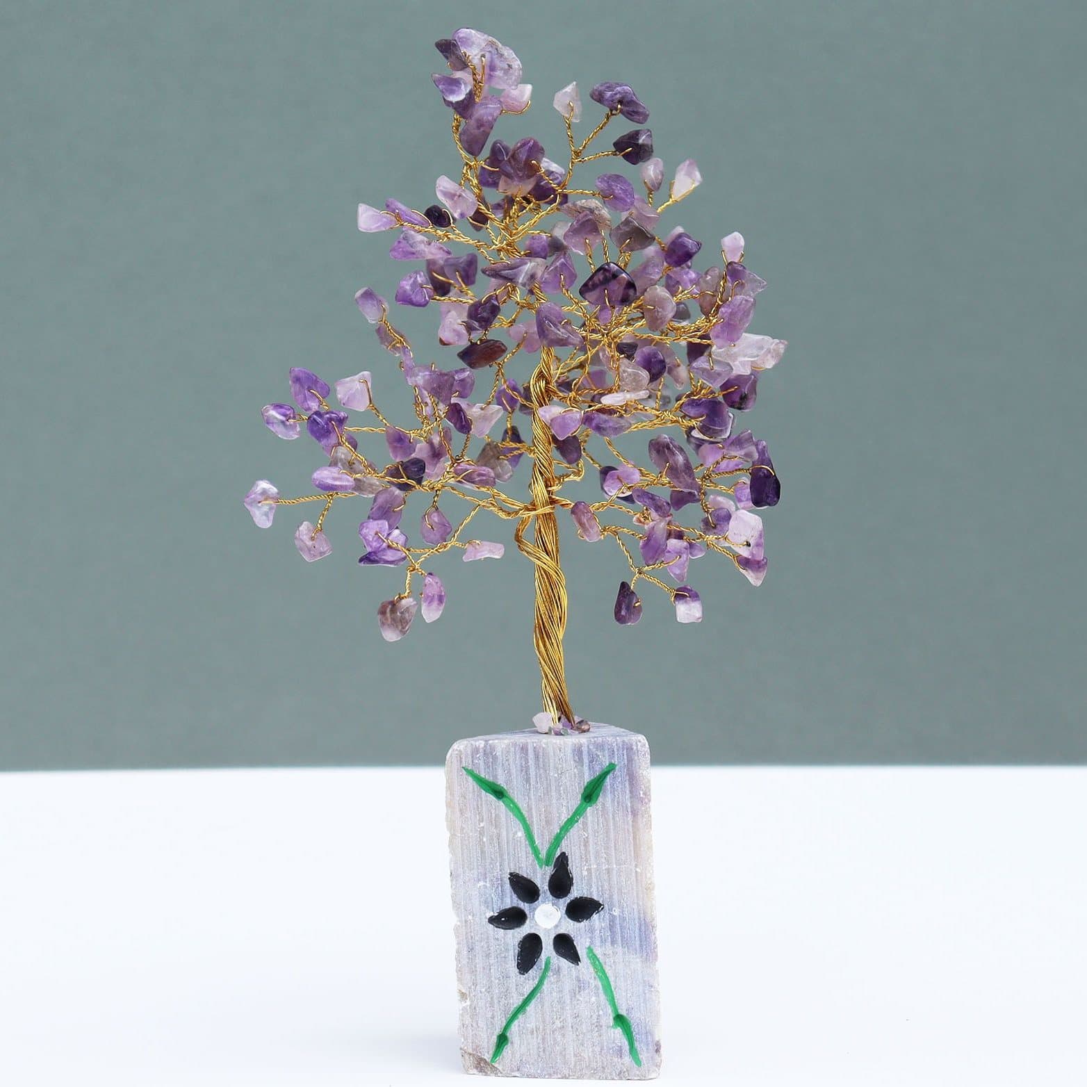 Amethyst gemstone tree with gemstone branches on a rock base