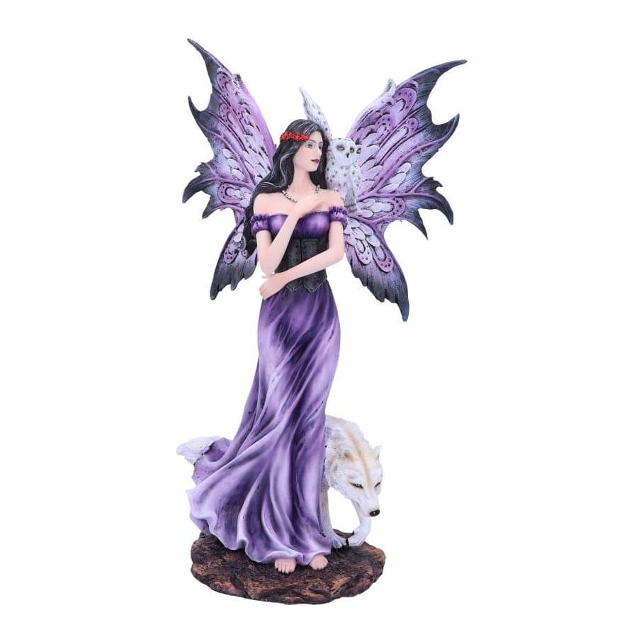Fairy figurine in a blue ball gown with a snowy owl on her shoulder and a white wolf
