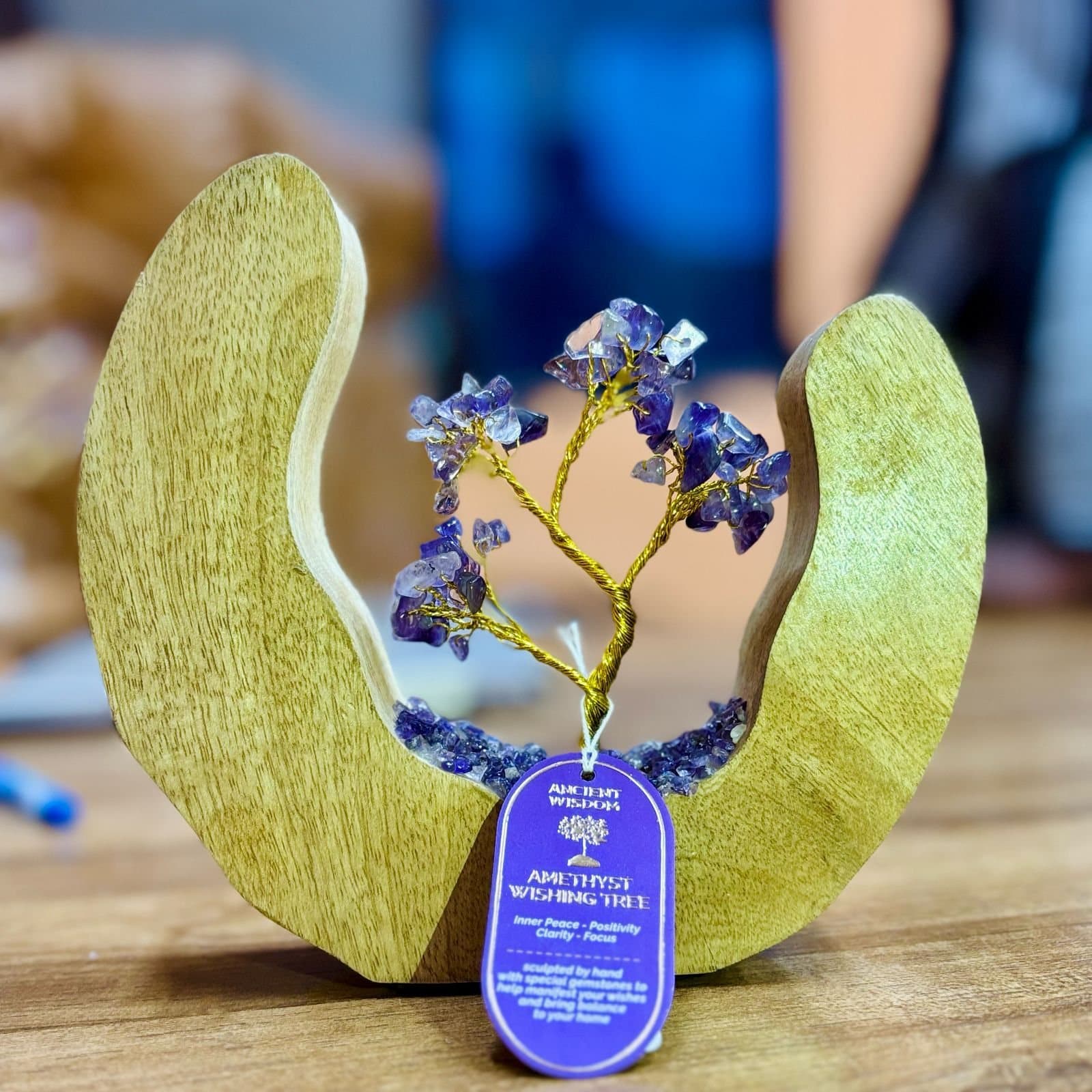 Amethyst chip gemstone tree on brass wire inside an open mango wood ring