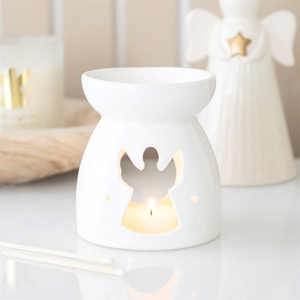 Ceramic oil burner with an angel-shaped cut-out