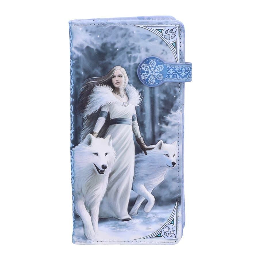 Embossed purse showing a woman and two white wolves in snow
