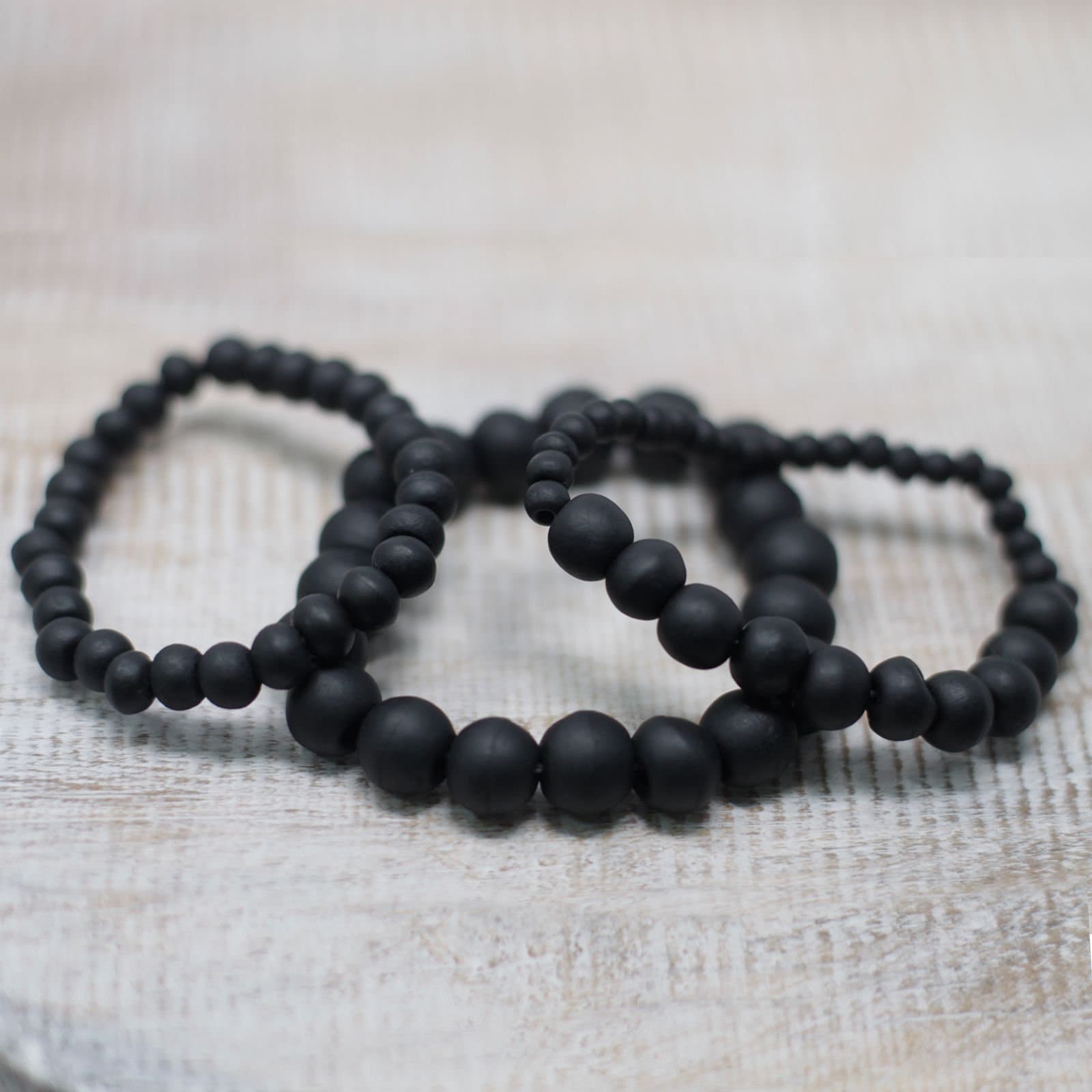 Elasticated blackwood bead bracelets made from coconut wood