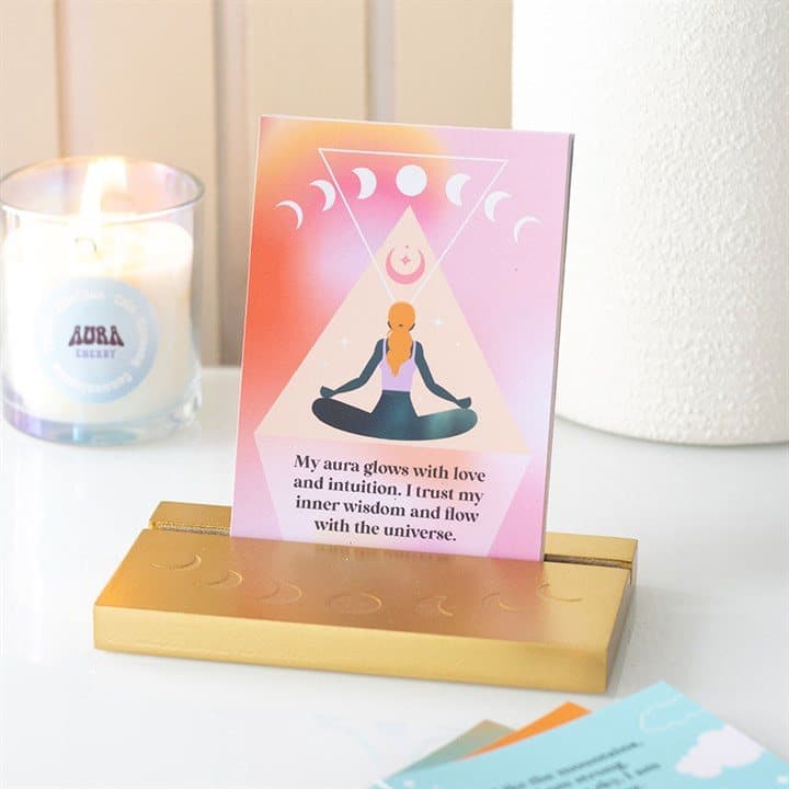 Illustrated affirmation card on a gold-tone wooden stand