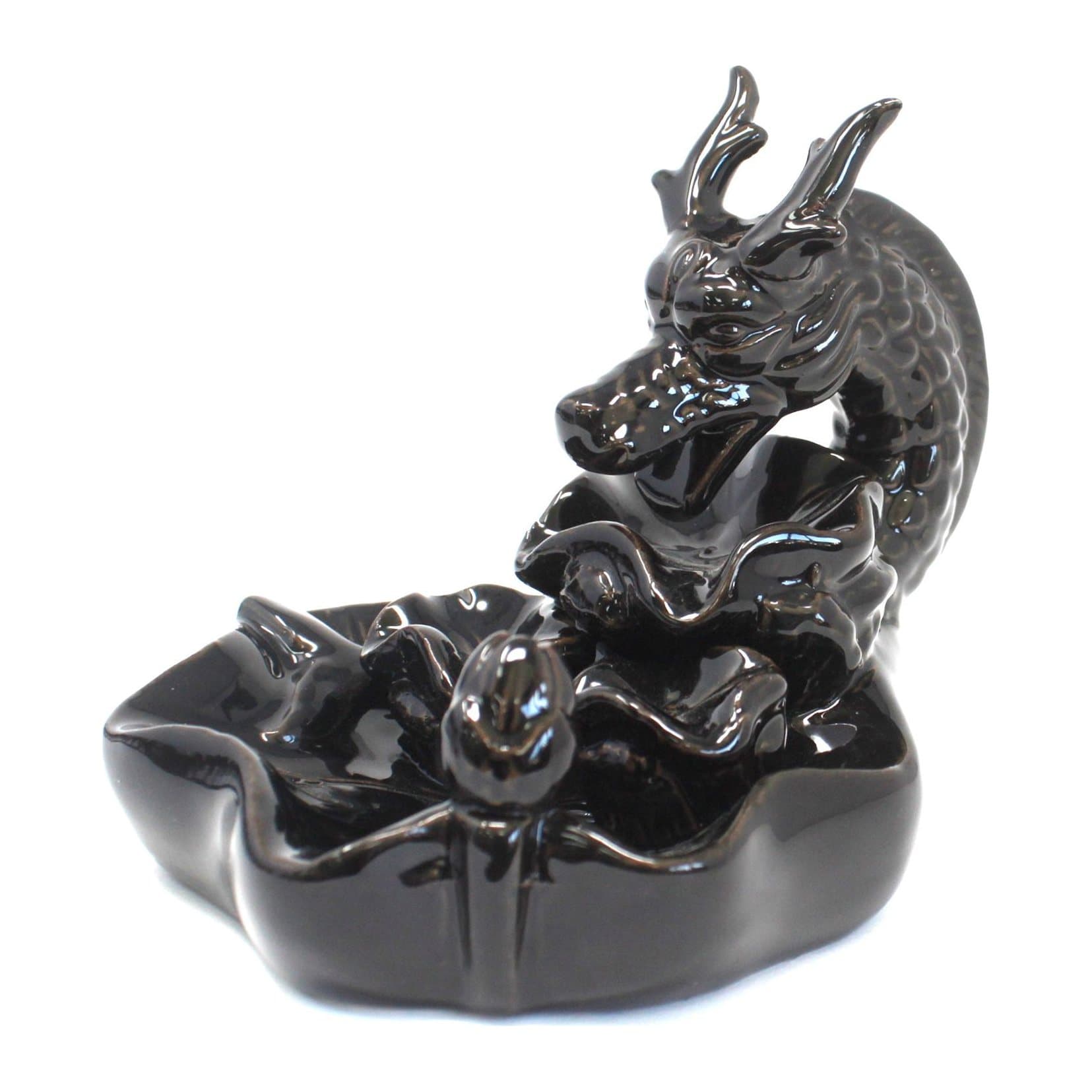 Ceramic dragon backflow incense burner with a dark pool at its base