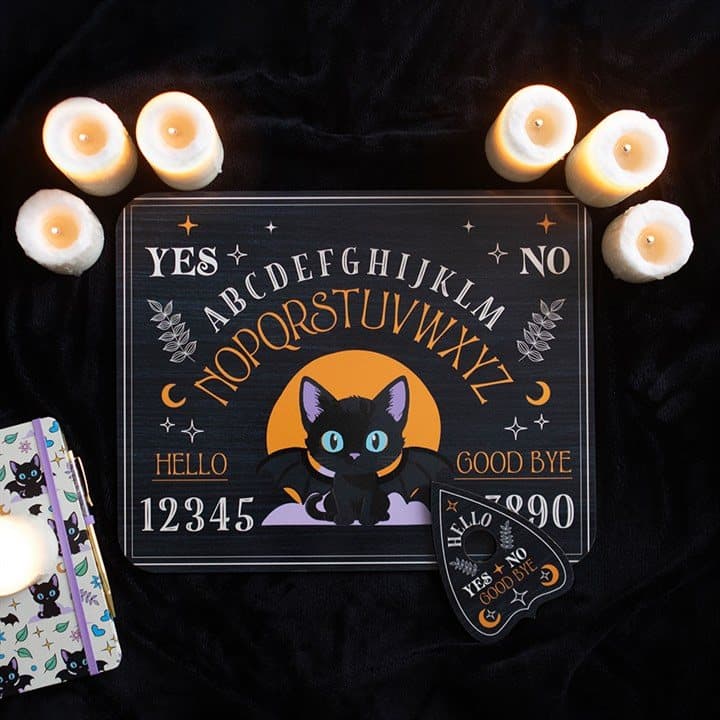 Talking board with a black cat, celestial details and a planchette