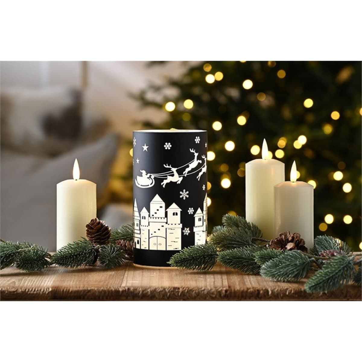Black glass tealight holder with white Christmas village and Santa's sleigh