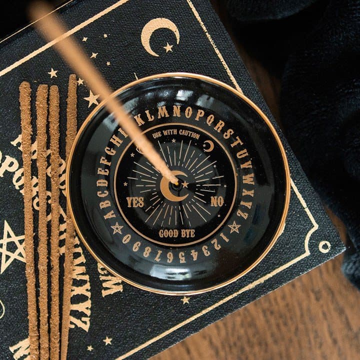 Black ceramic incense dish with a gold talking board design