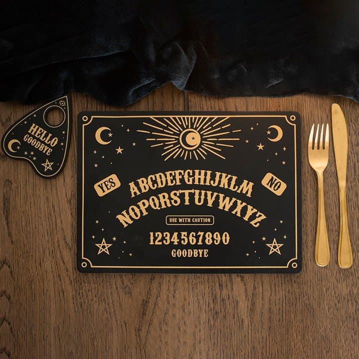 Placemat and coasters with a celestial black and gold talking board design