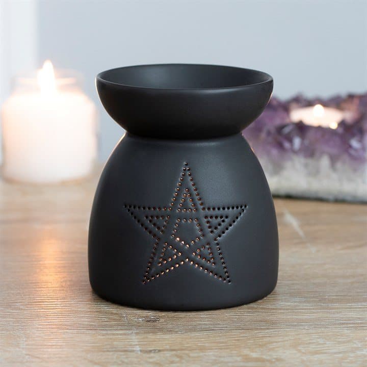 Matt black ceramic oil burner with a pentagram cut out of its design