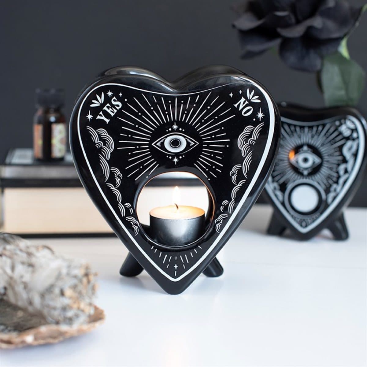 Black planchette oil burner with white celestial artwork and all-seeing eye