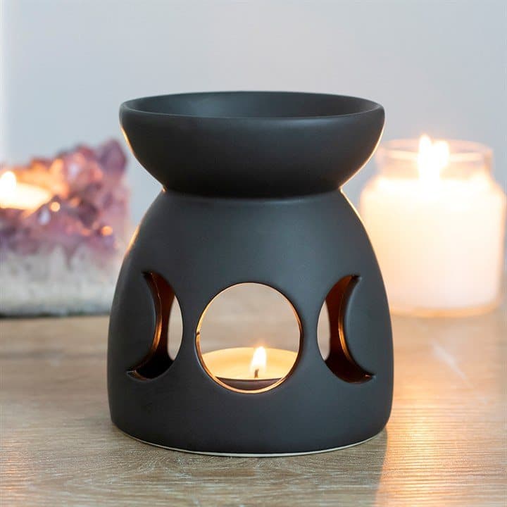 Matt black ceramic oil burner with a cut-out triple moon design
