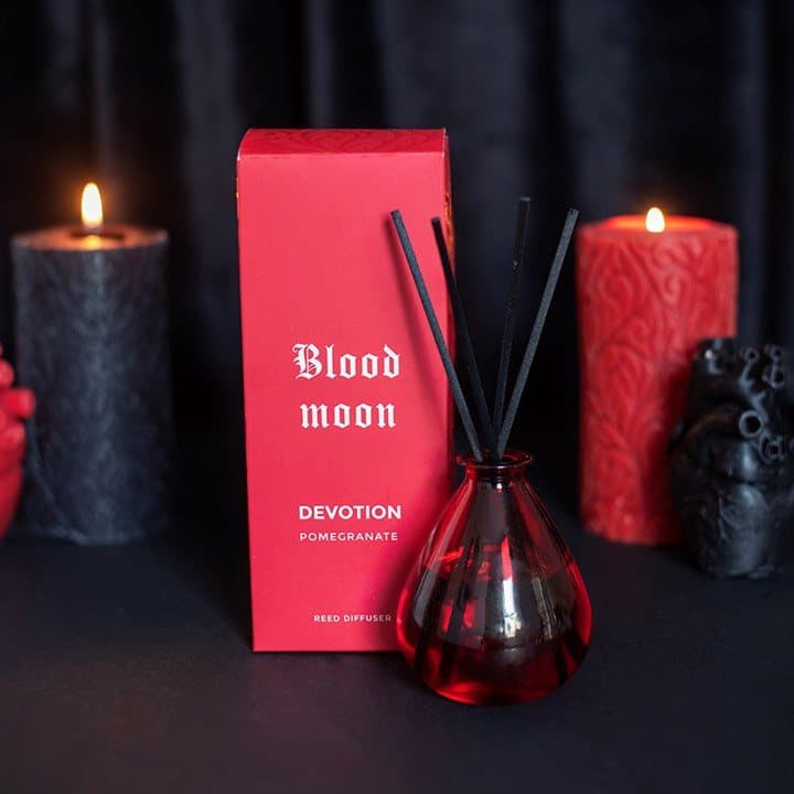 Glass pomegranate reed diffuser labelled Devotion