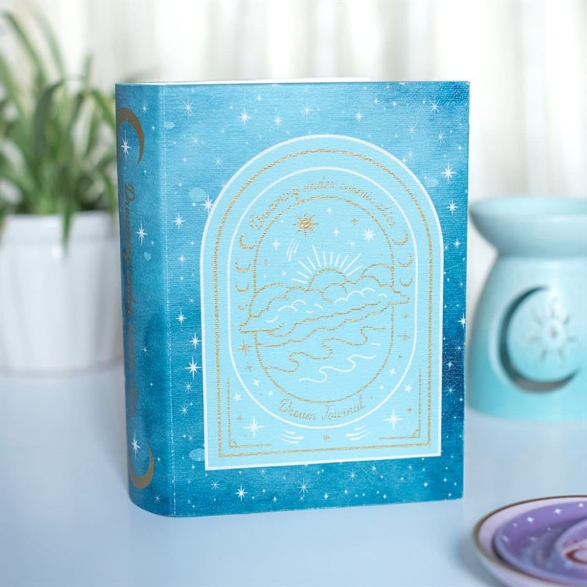 Blue book shaped box with moon, star and cosmic design