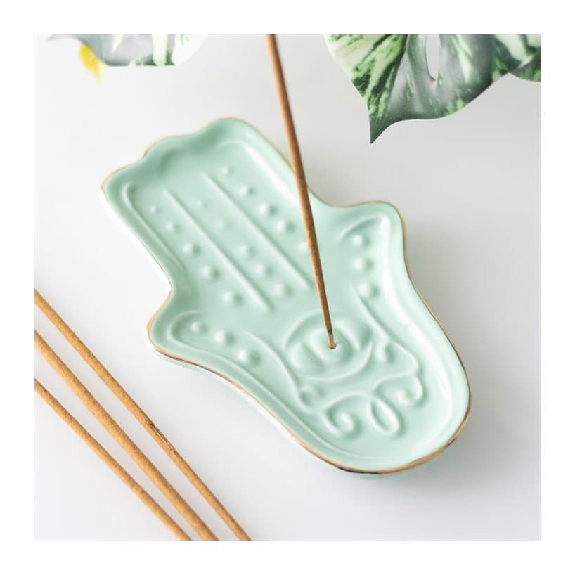 Blue ceramic incense stick holder shaped like a hamsa hand