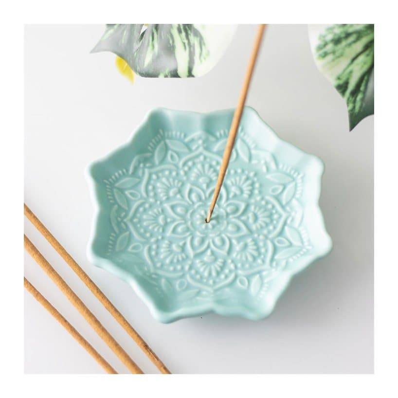 Blue ceramic incense stick holder shaped like a mandala