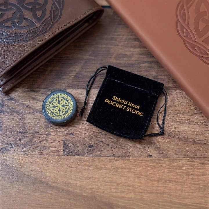 Box of 24 smooth black pocket stones with gold-toned Celtic shield knots in a wooden case