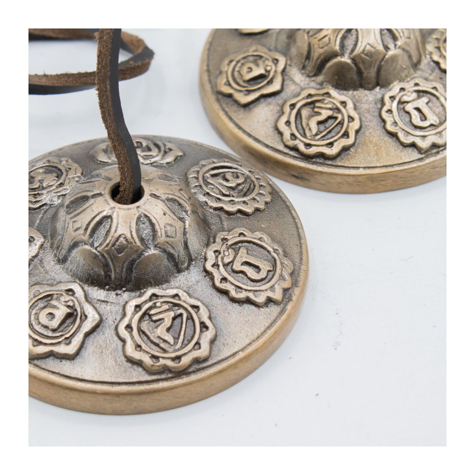 Brass Tibetan tingsha bells with Seven Chakra symbols and a leather cord