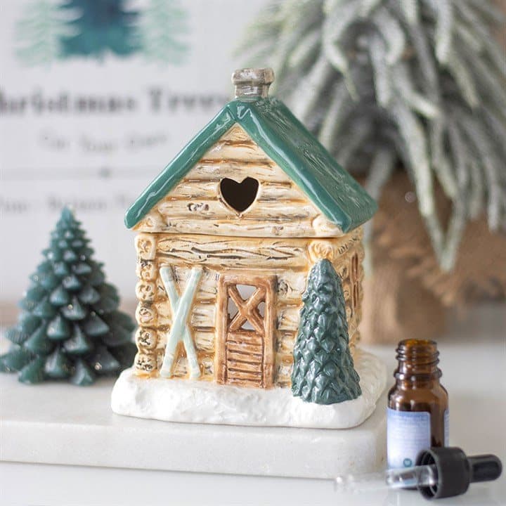 Ceramic oil burner shaped like a cosy ski chalet