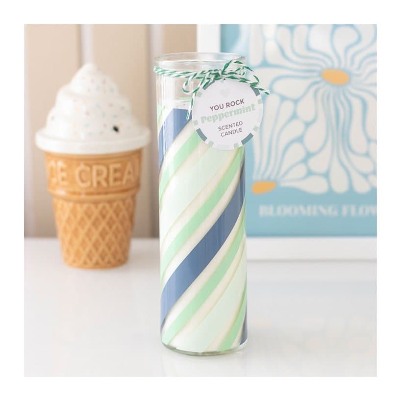 Green candy stripe glass tube candle styled like a stick of rock