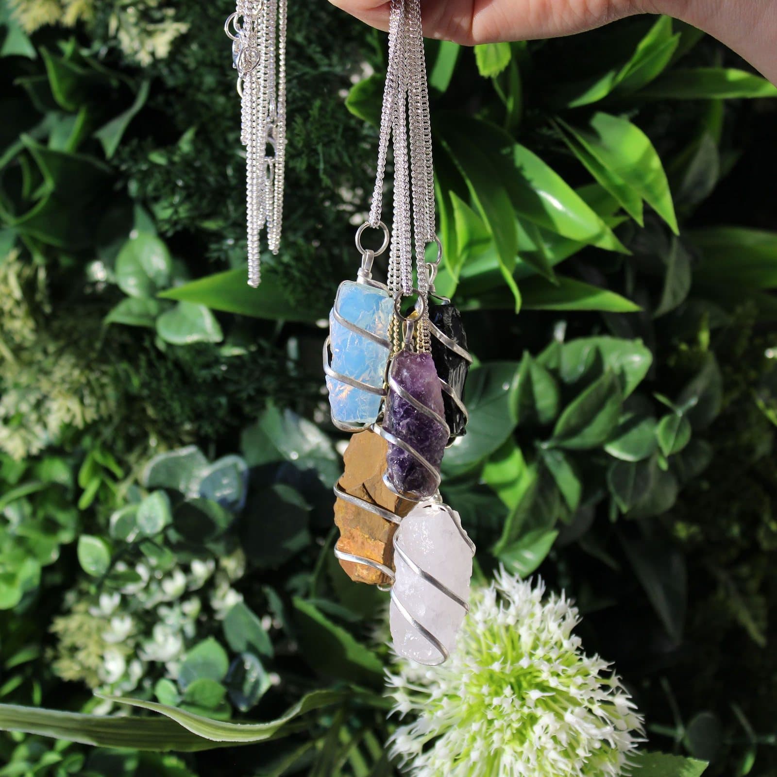 Raw purple amethyst pendant wrapped in thin wire on a chain