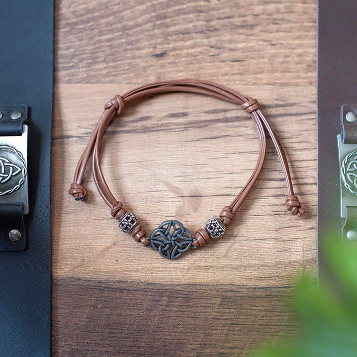 Brown leather cord bracelet with a Celtic shield knot centrepiece