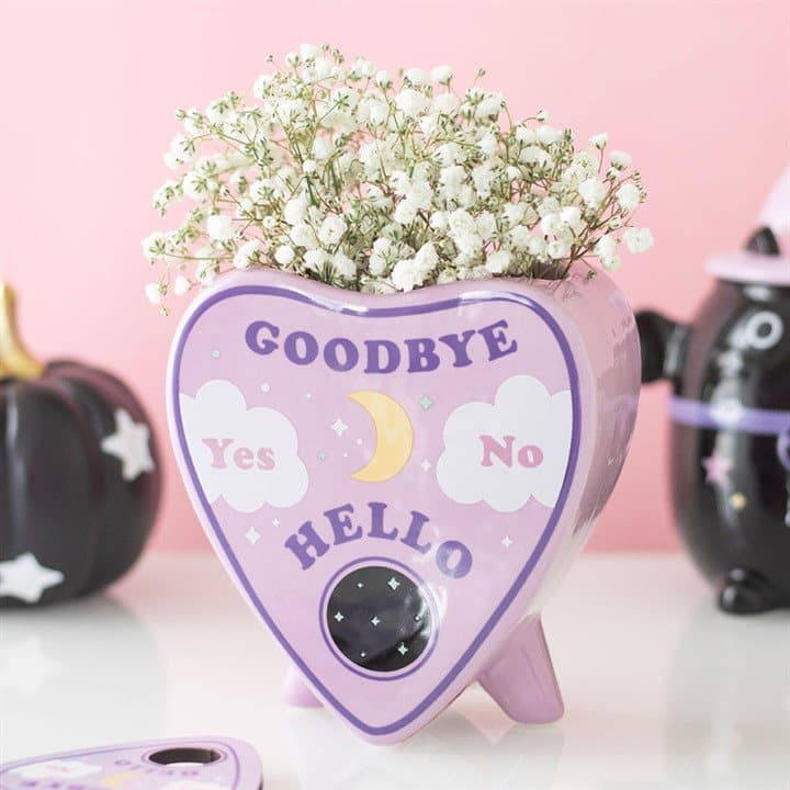 Ceramic planchette-shaped vase with a pastel talking board design