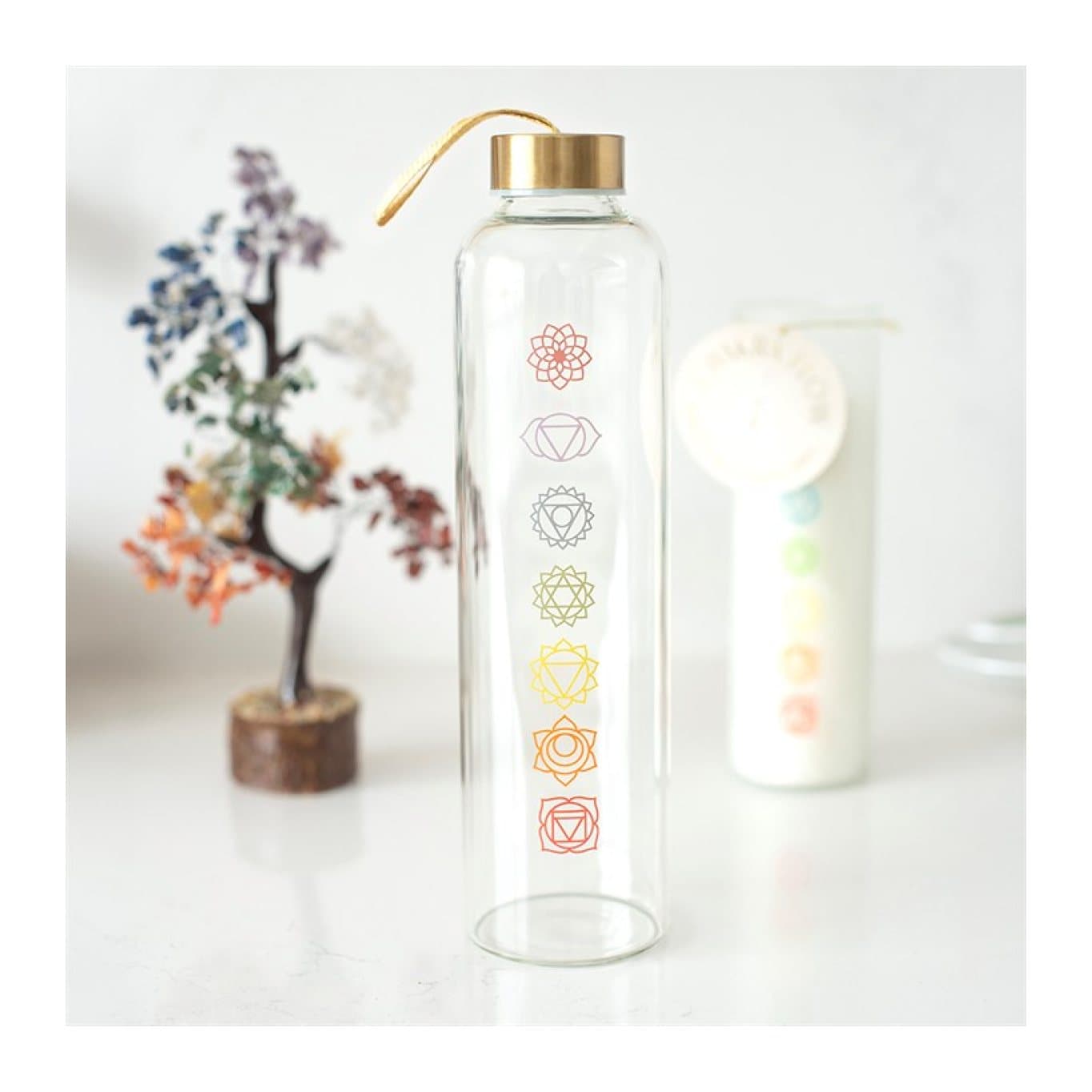 Glass water bottle with colourful chakra symbols and a carry loop