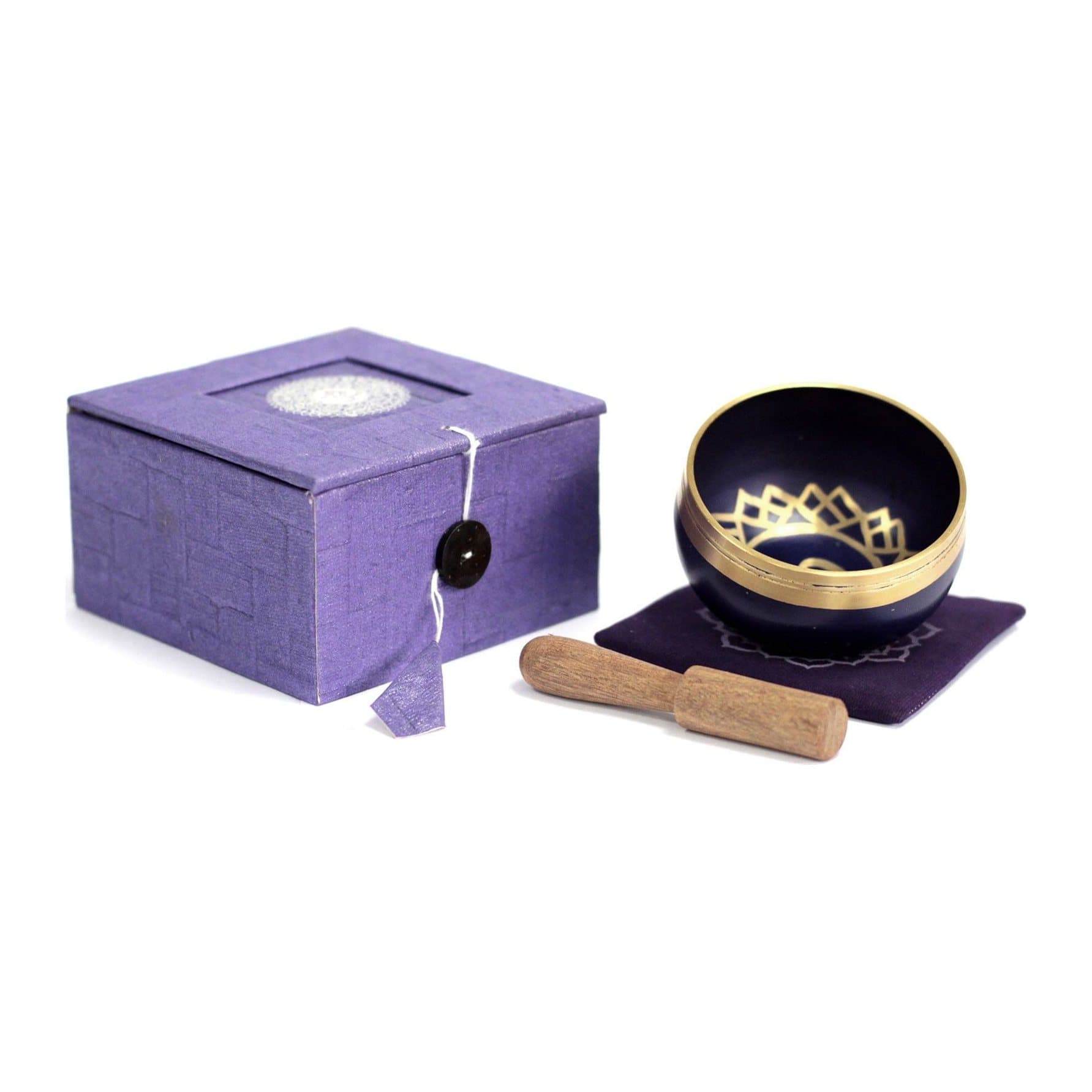 Small brass crown chakra singing bowl with a wood stick