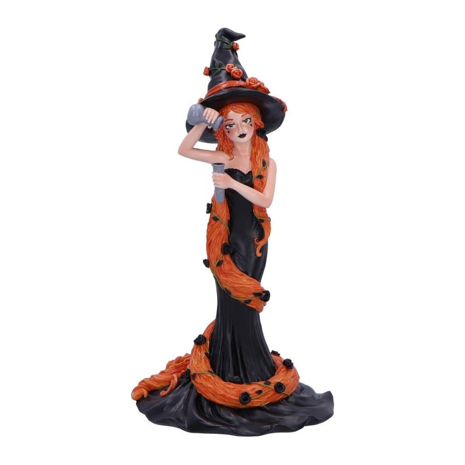 Cinnamon witch figurine in a black hat with orange roses and long ginger hair