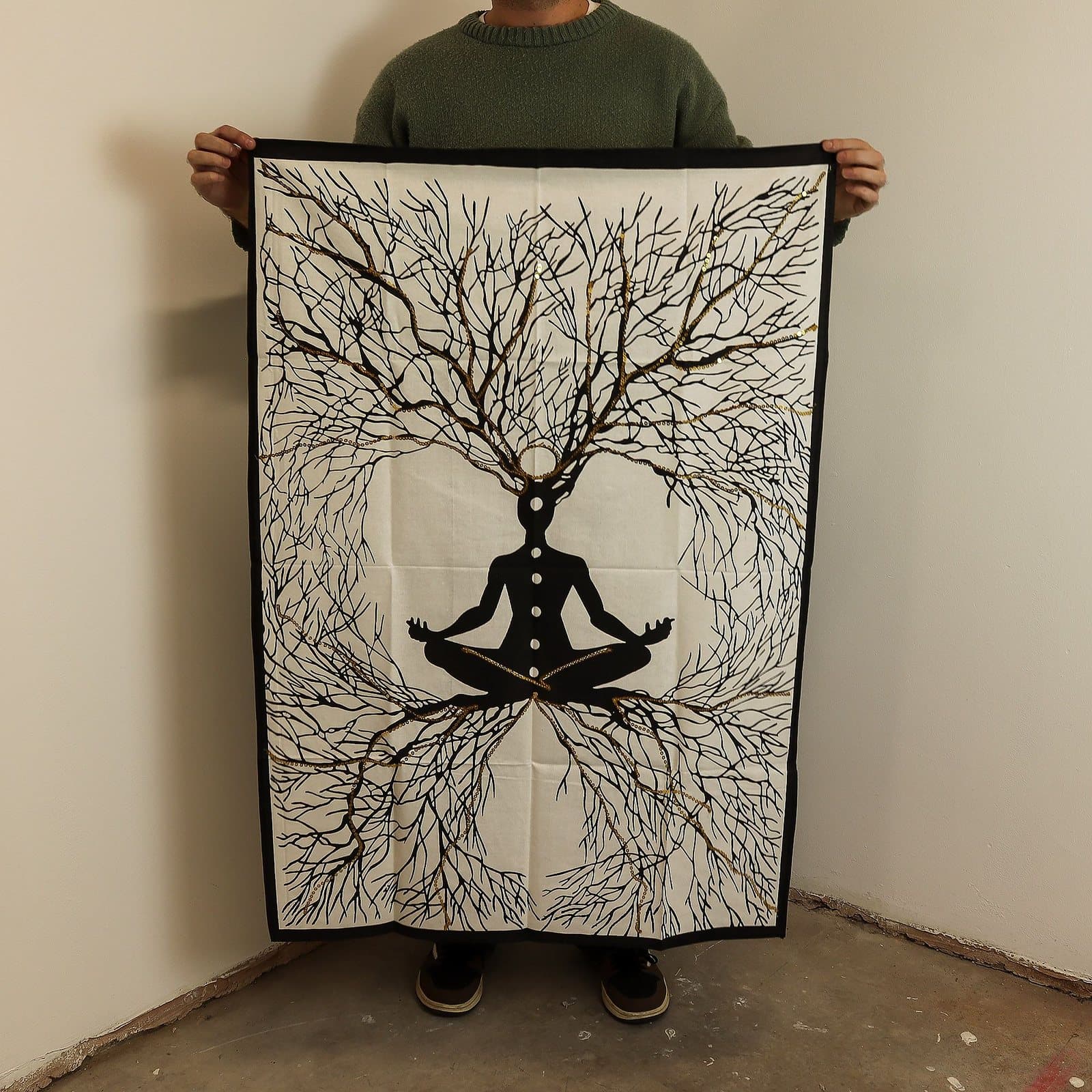 Cotton wall hanging of a meditative figure with branching roots