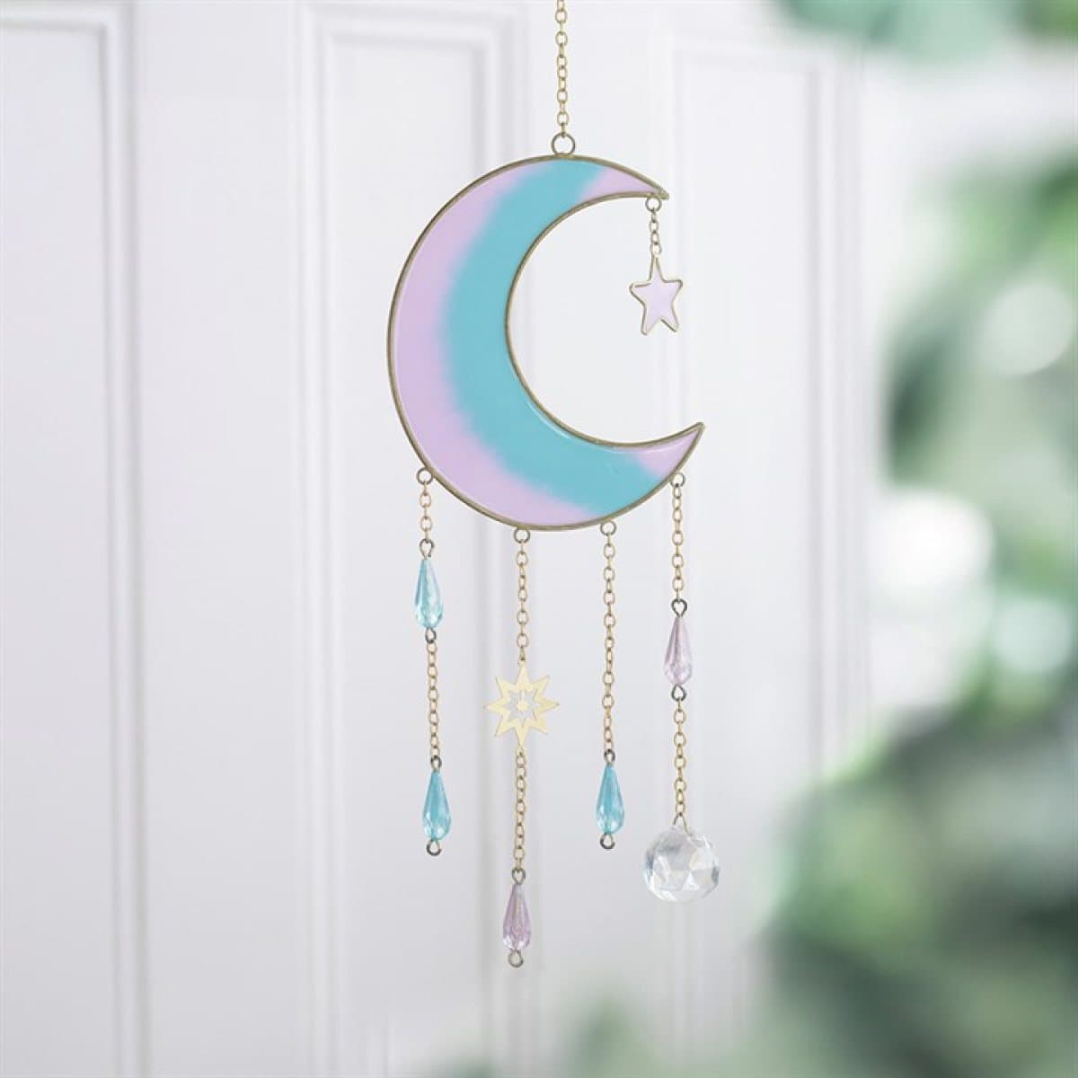 Pastel rainbow crescent moon suncatcher with gold-tone edges and celestial charms