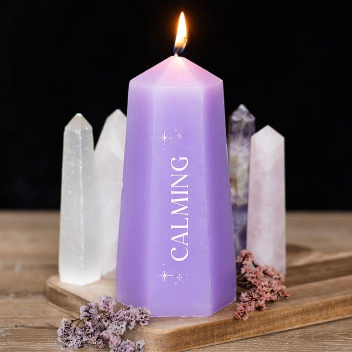 Purple crystal tower candle with a rough amethyst hidden at the bottom