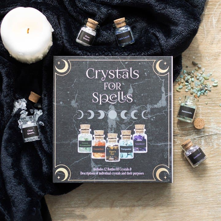 Twelve glass bottles of crystal chips in a box