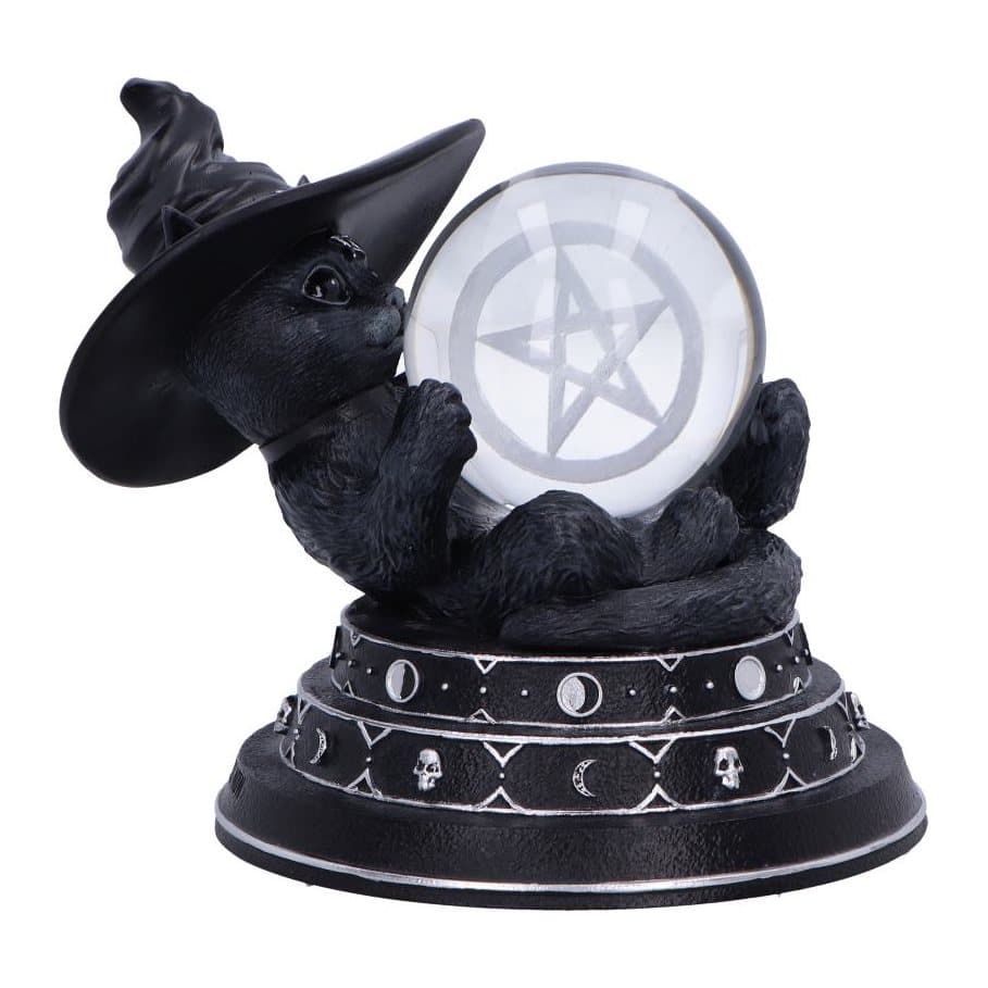 Witch cat figurine lying on her back with a glass ball on a moon and skull base