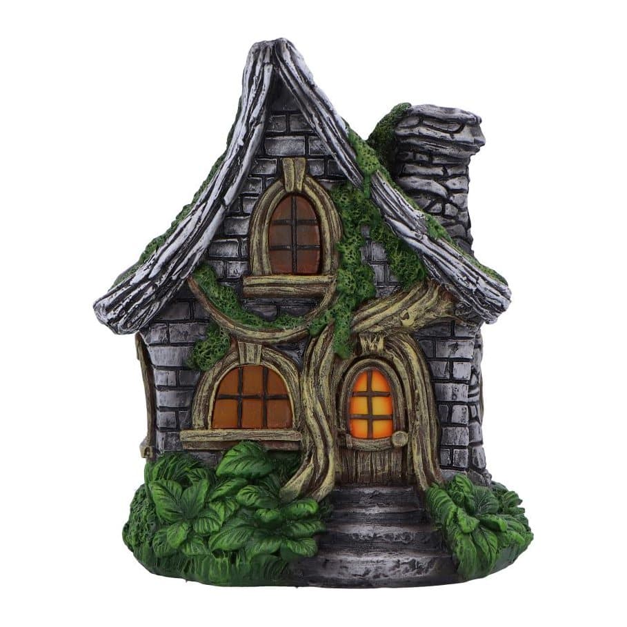 Whimsical fairy cottage with glowing windows, curved roof and stone chimney