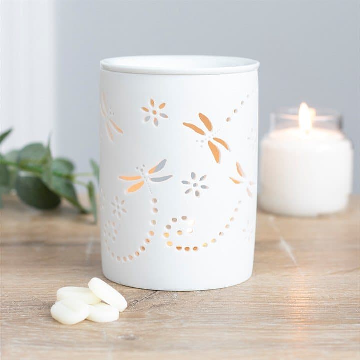 White ceramic oil burner with a dragonfly cutout design