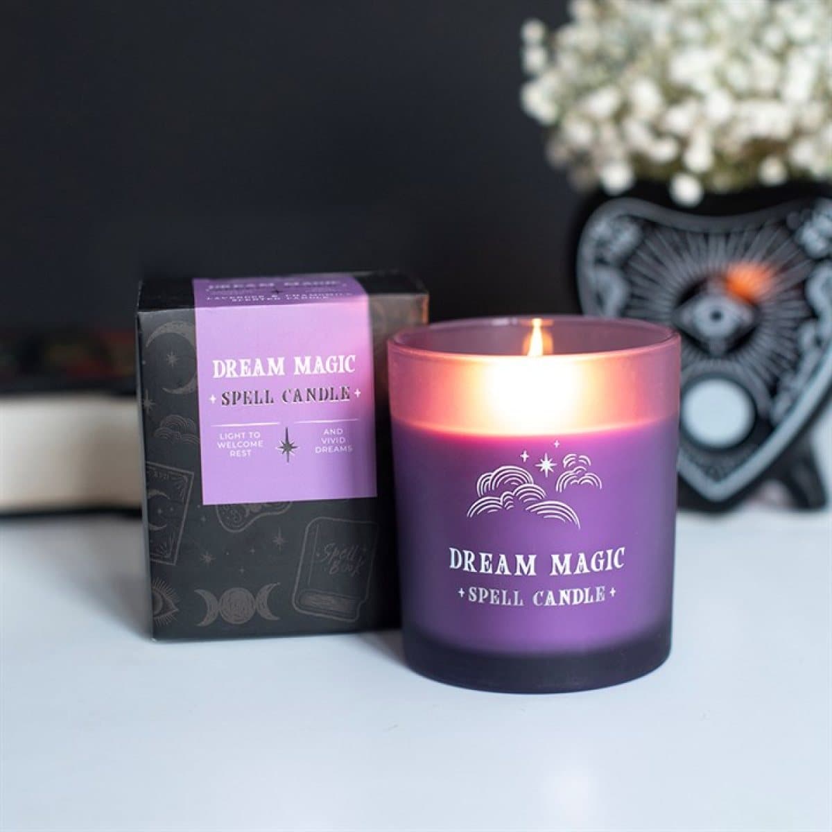 Dream Magic lavender and chamomile scented candle in a purple glass jar