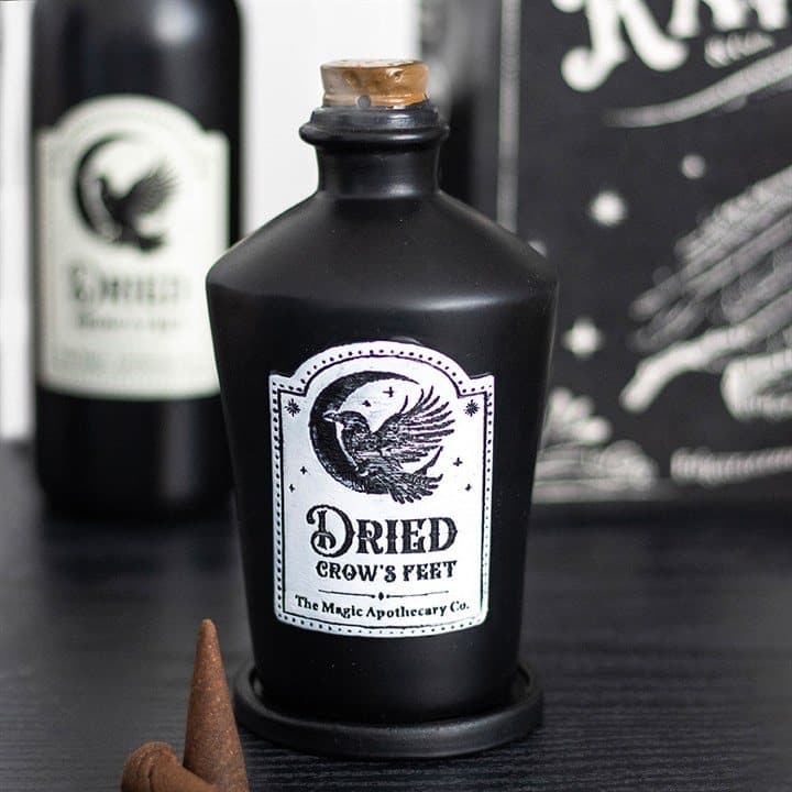 Potion bottle shaped resin incense cone holder with a Dried Crow's Feet label
