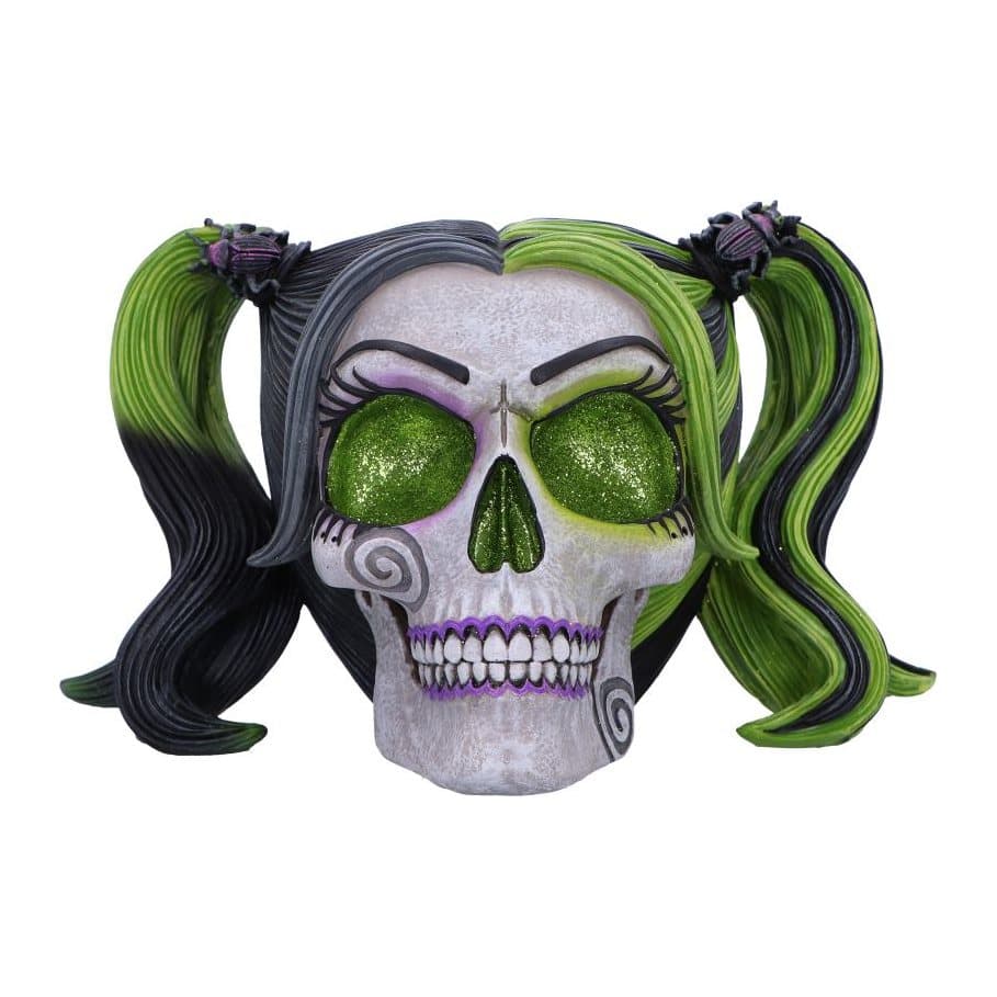 Black and green skull figurine with green glitter eye sockets and bugs on pigtails