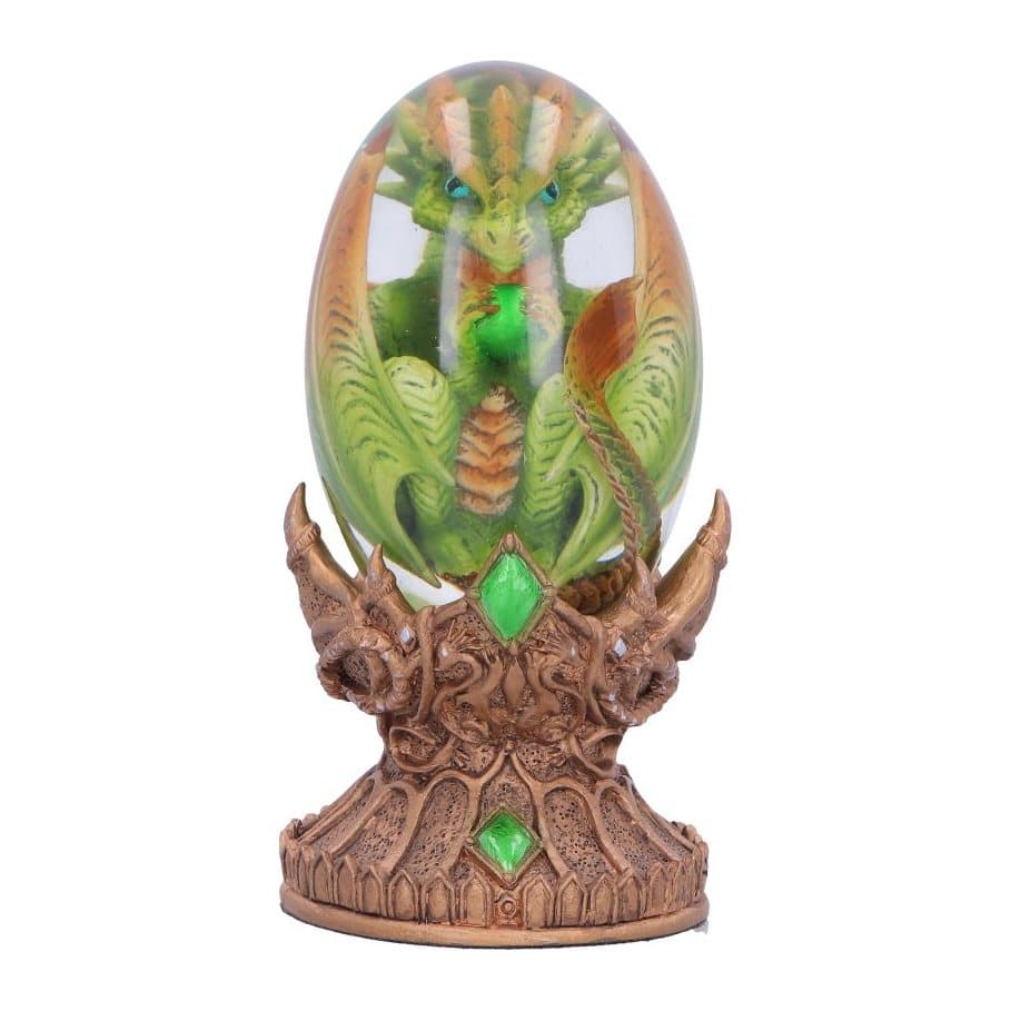 Green dragon figurine inside a clear egg on a green and bronze stand