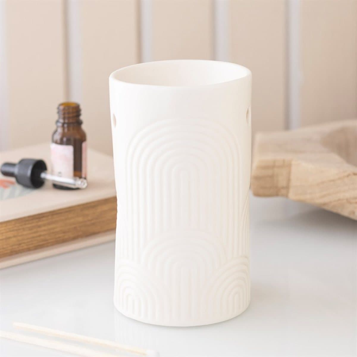 Cream ceramic oil burner and wax warmer with an embossed arch design