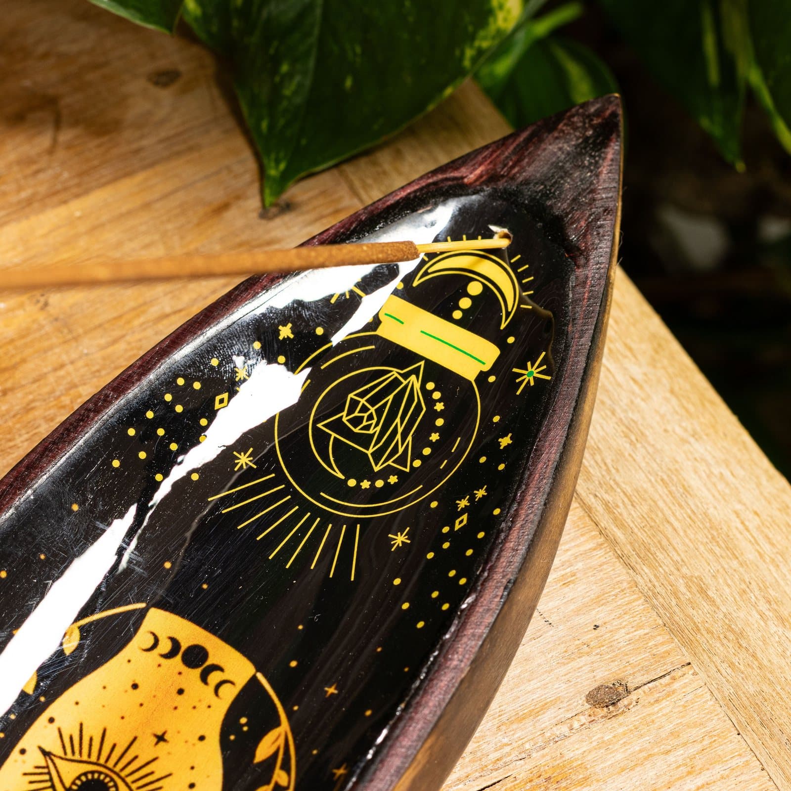 Long dark enamel incense bowl with golden hamsa hand and mango wood edges
