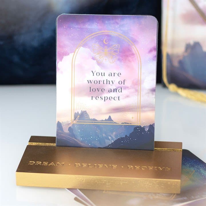 Ten ethereal sky affirmation cards beside a wooden stand