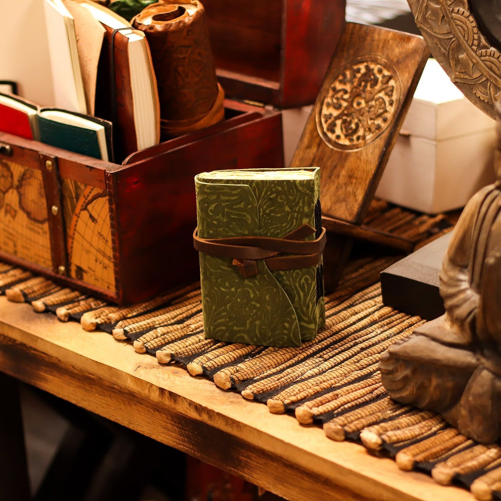 Compact leather notebook with embossed green maze design