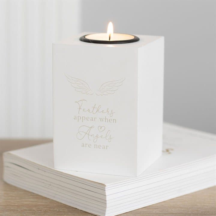 White angel wing tealight holder with Feathers appear when angels are near text