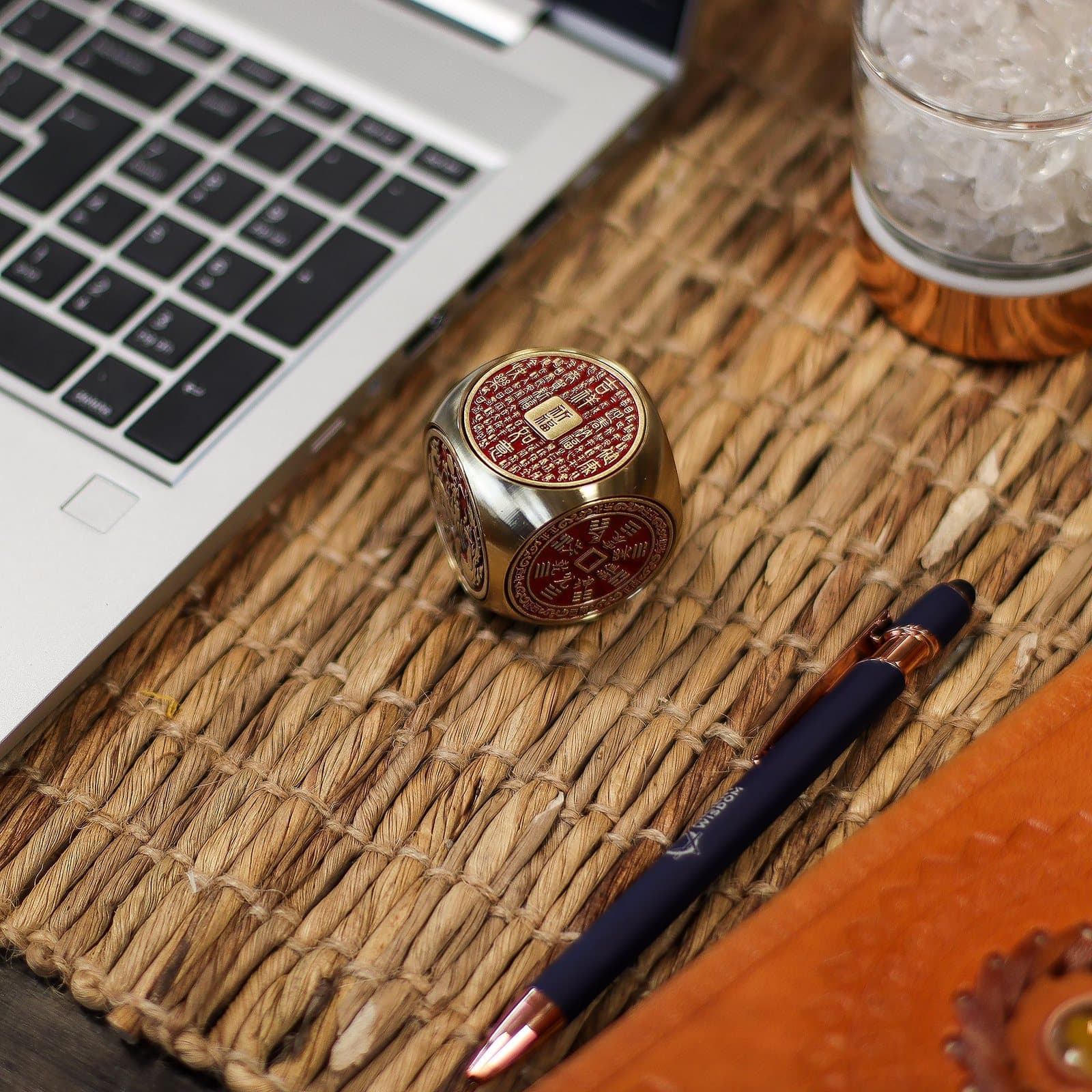 Red and brass prosperity cube with traditional symbols
