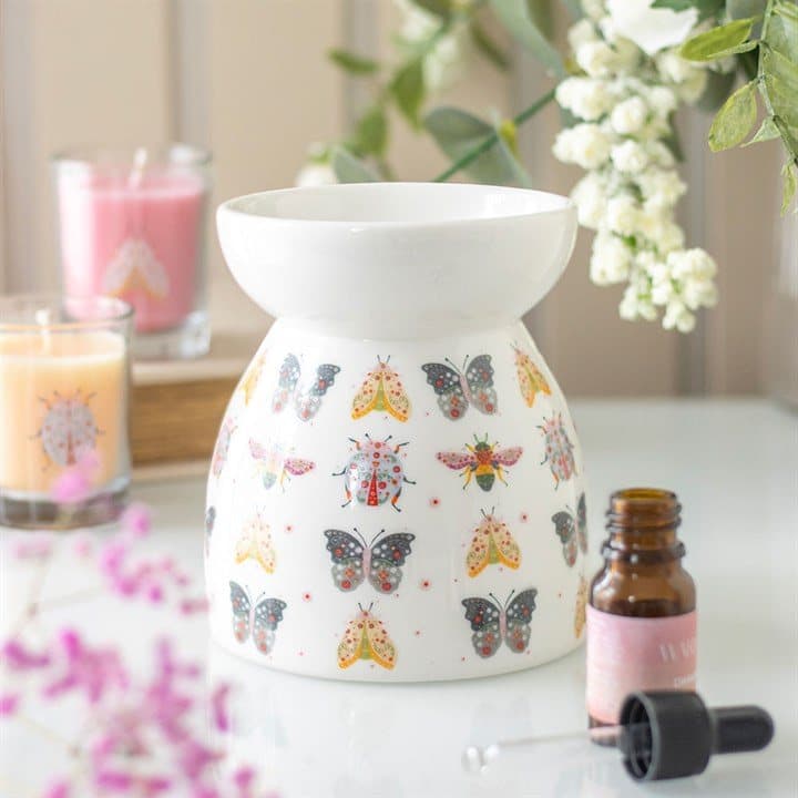 Ceramic oil burner and wax warmer with a floral bug design